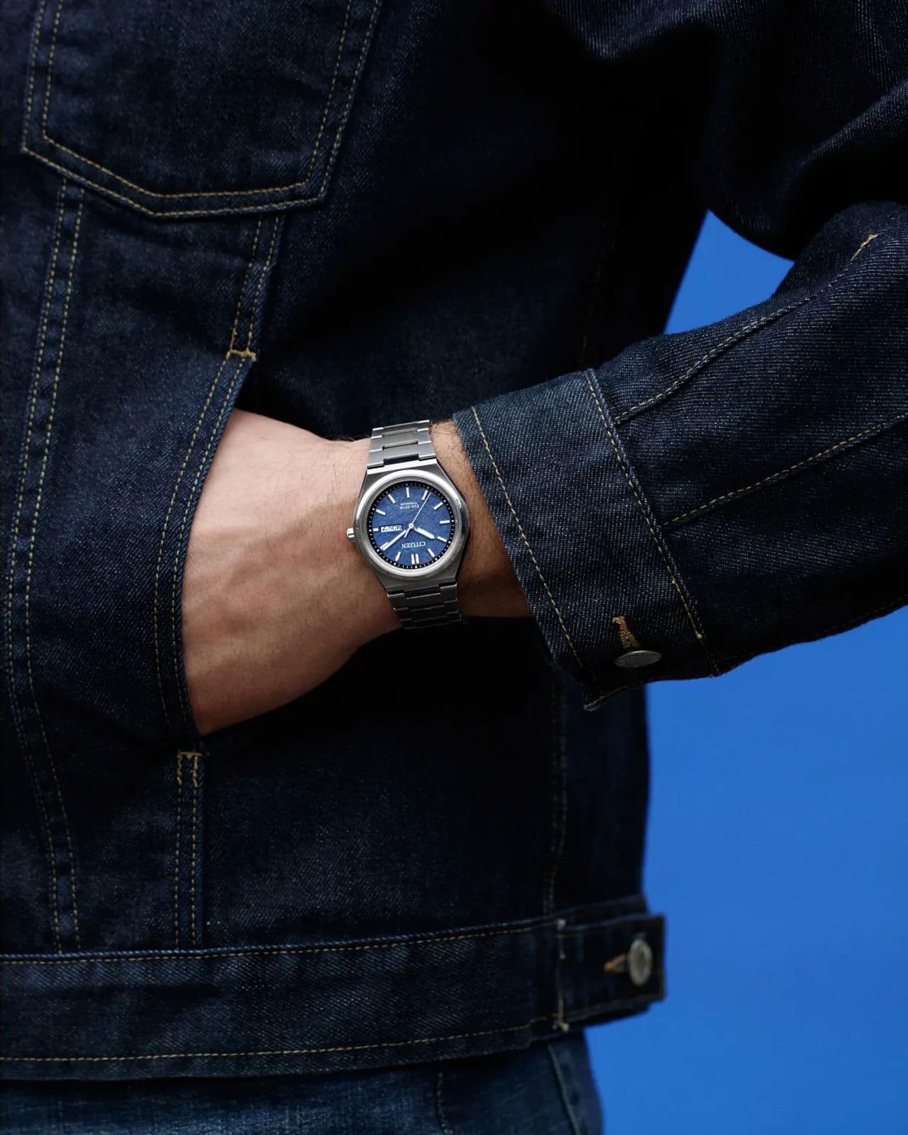 Citizen with a vibrant blue dial on a person's wrist.